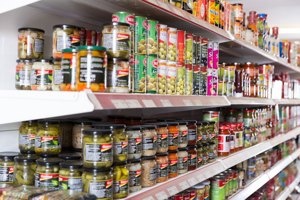 BARCELONA, SPAIN - JUNE 4, 2018: Image of shelves with variety products in cans in the supermarket
