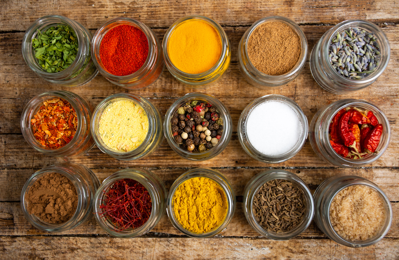 Large collection of spices in small bowls flat lay
