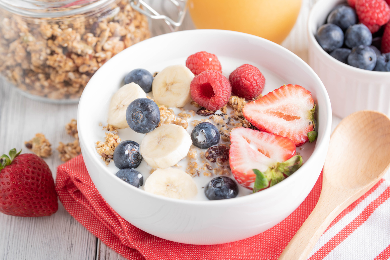 pouring milk in granola, breakfast image