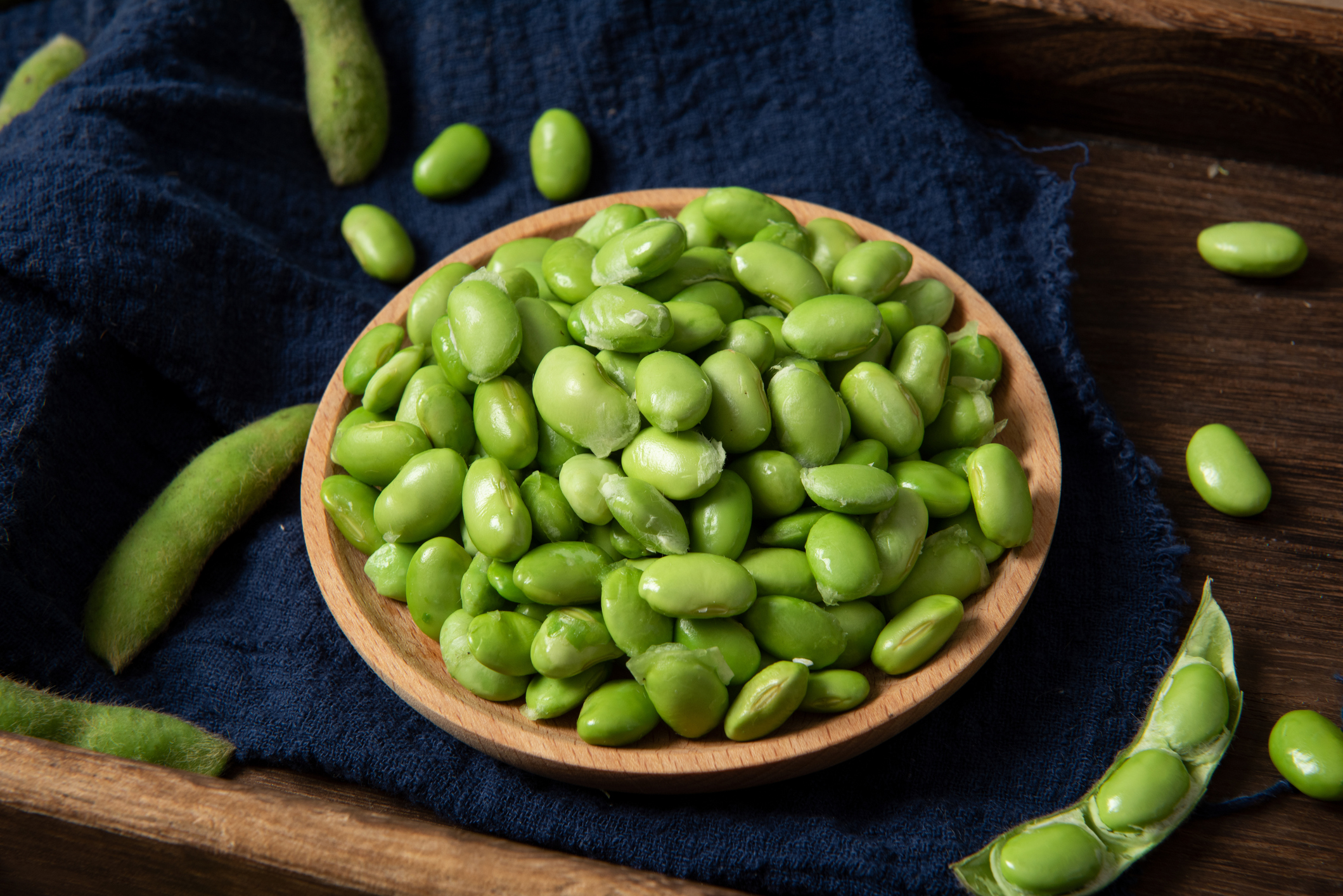 green soy bean in pods on wooden background. fresh beans.