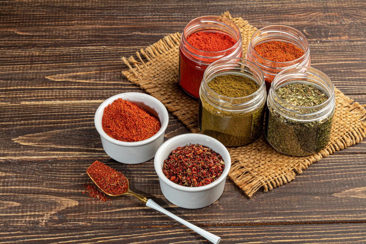 A set of spices on a light background in a glass bowl. Enhancement of taste. copy space