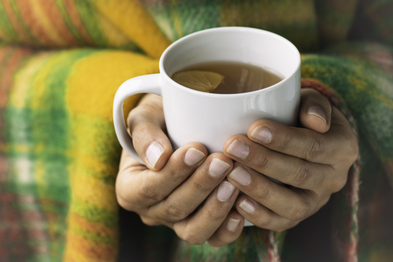 Woman holding a cup of tea.
