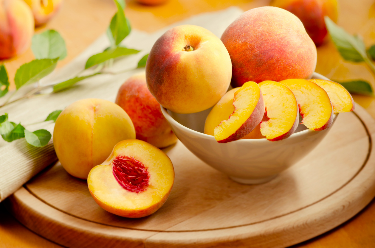 Fresh peaches on a wooden board